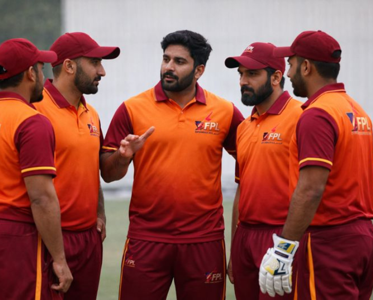 Cricket team discussing strategy at FourRise Premier League match in Telangana